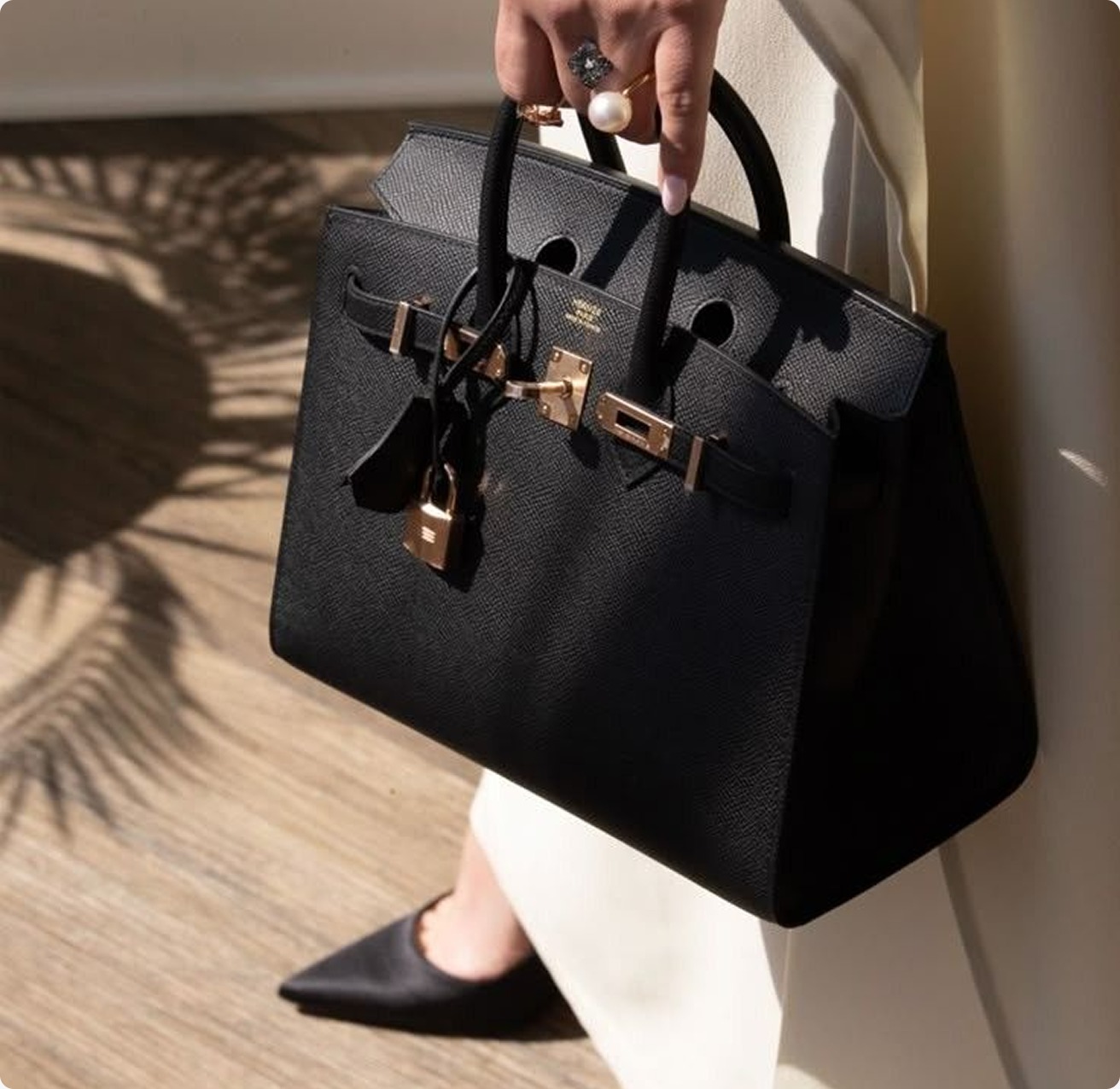 Black Hermès Birkin bag carried by a woman
