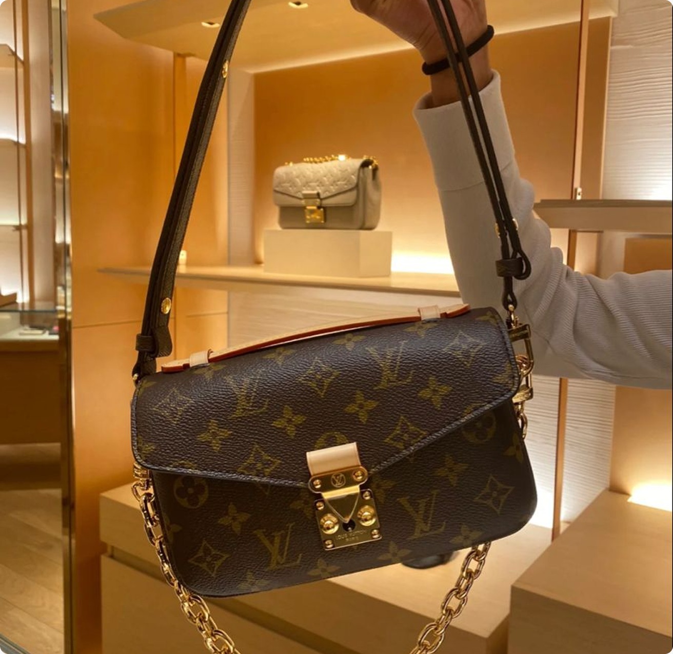 Louis Vuitton monogram shoulder bag displayed in a boutique